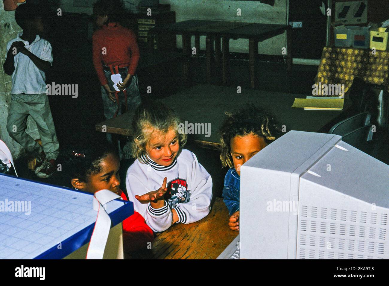 Pupils using a desktop computer in a primary school in 1984. Early use of ICT (Information Computer Technology) in the UK Stock Photo
