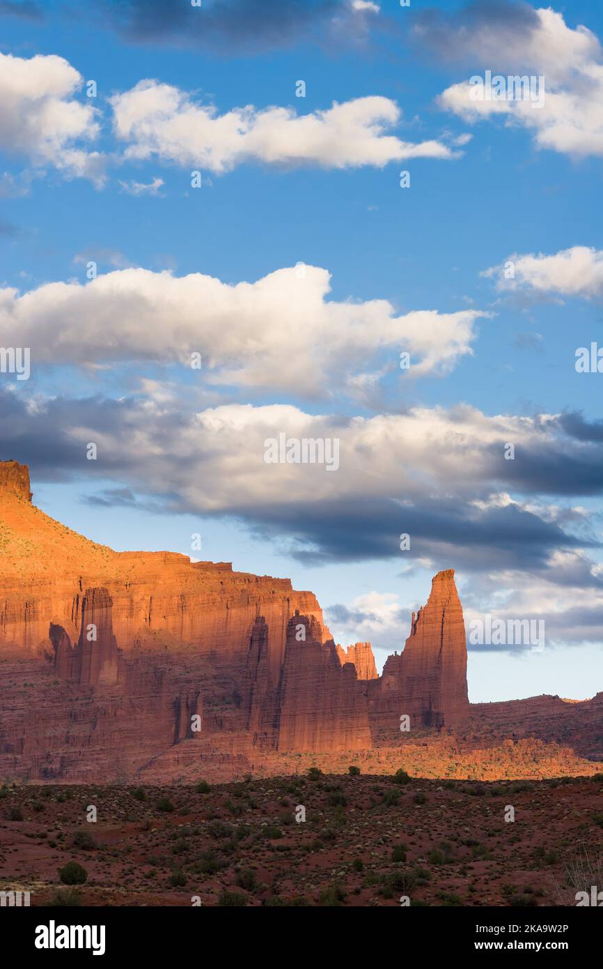 Spotlighting on the Fisher Towers at sunset near Moab, Utah.  Kingfisher Tower, left, the Cottontail & the Titan at right. Stock Photo