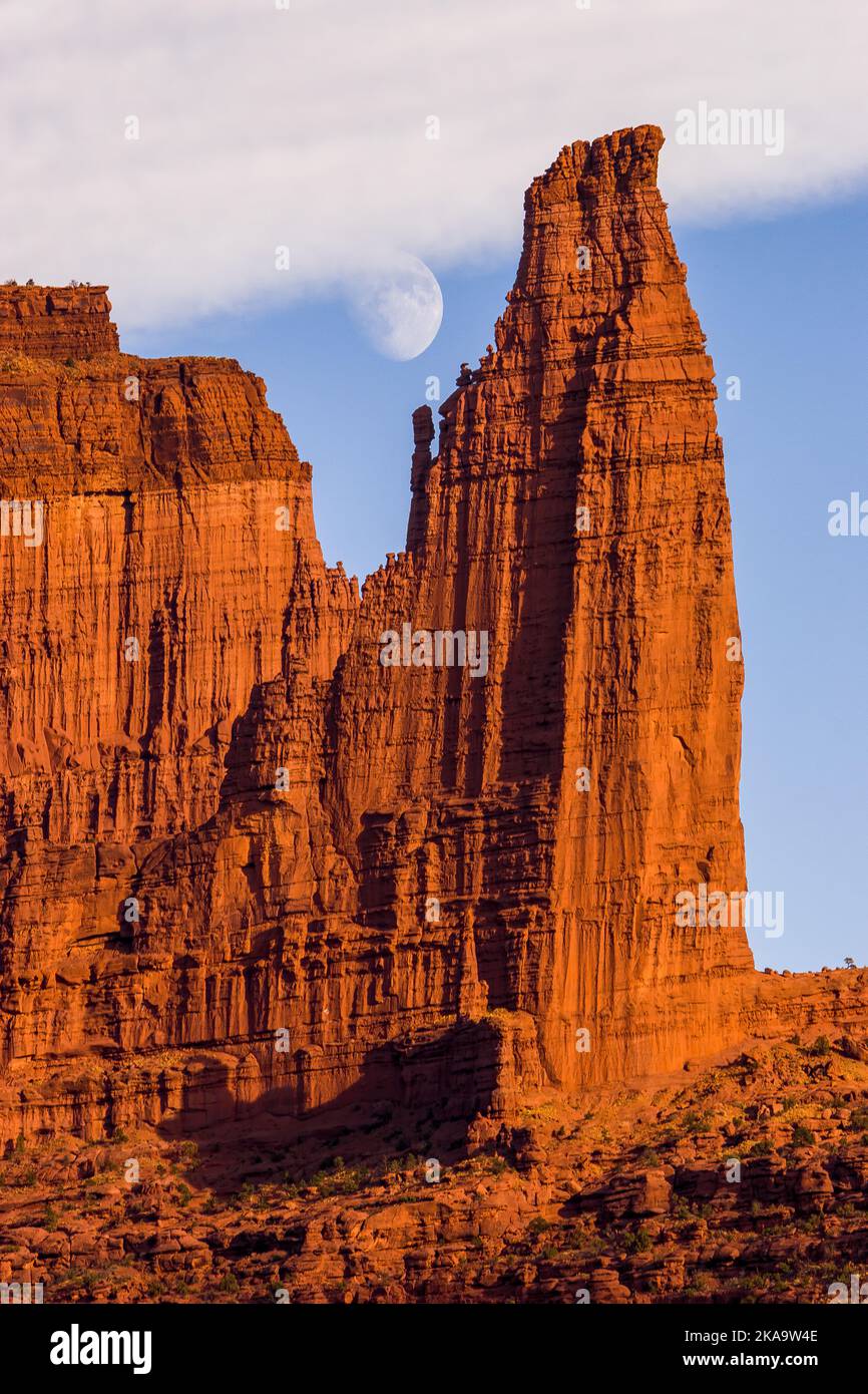 Rising moon by the Titan in the Fisher Towers, eroded Cutler sandstone rock formations near Moab, Utah.  The Titan is the tallest free-standing sandst Stock Photo