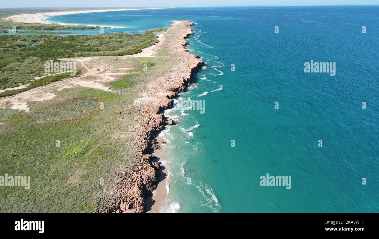 A mesmerizing view of green beach with the sea on a sunny day Stock ...
