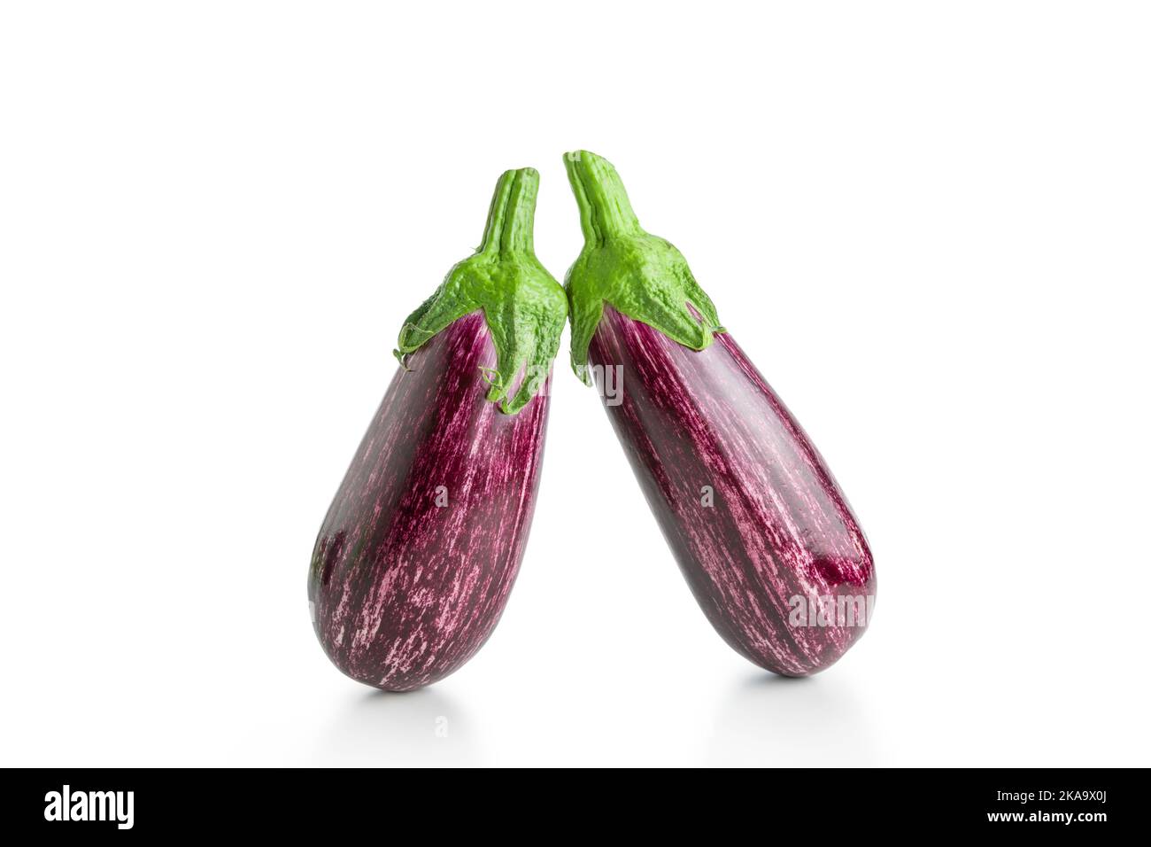 Two ripe graffiti eggplants isolated on a white background. Food concept. Stock Photo