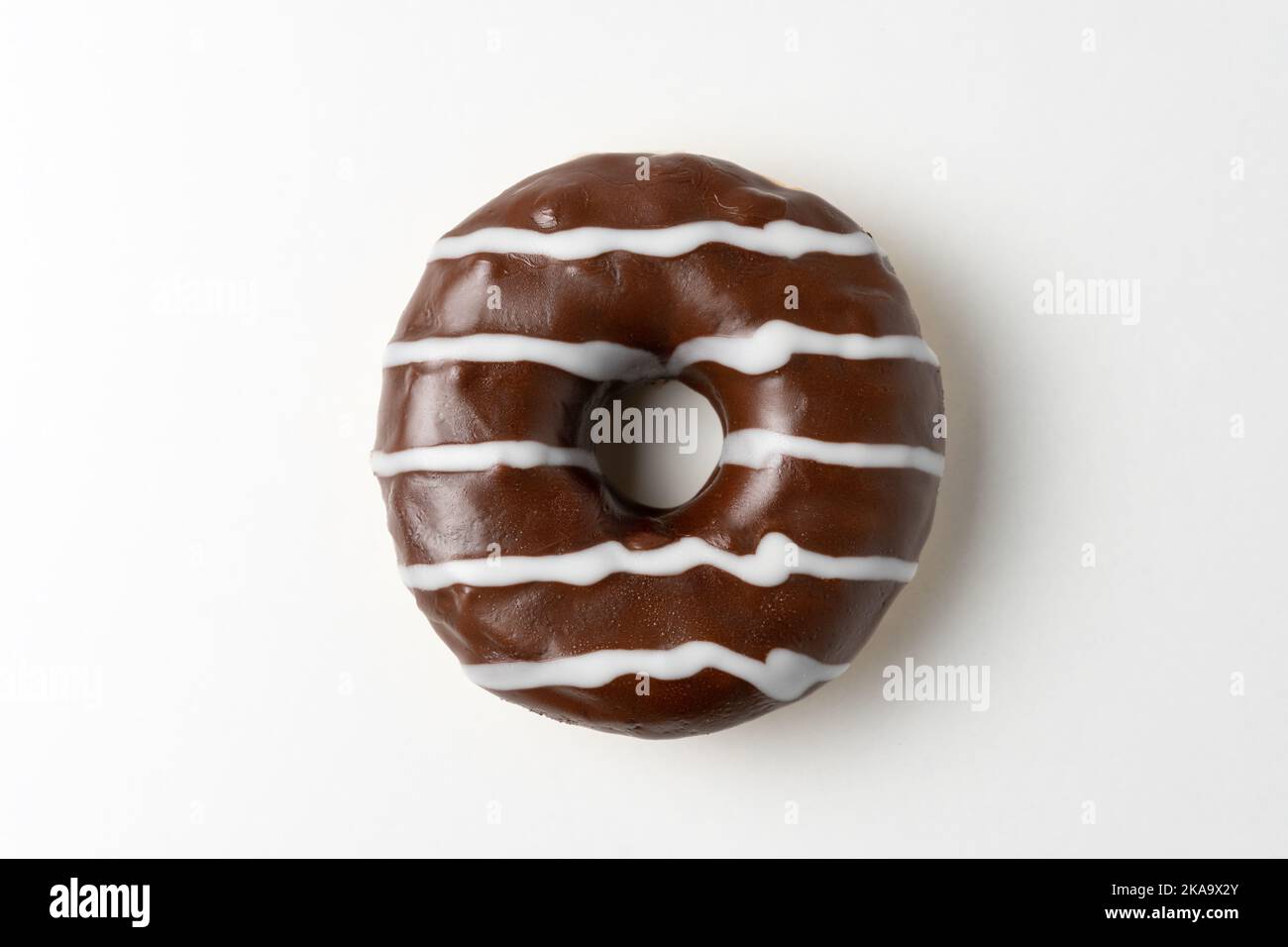 Chocolate donut on white background. Top view Stock Photo - Alamy