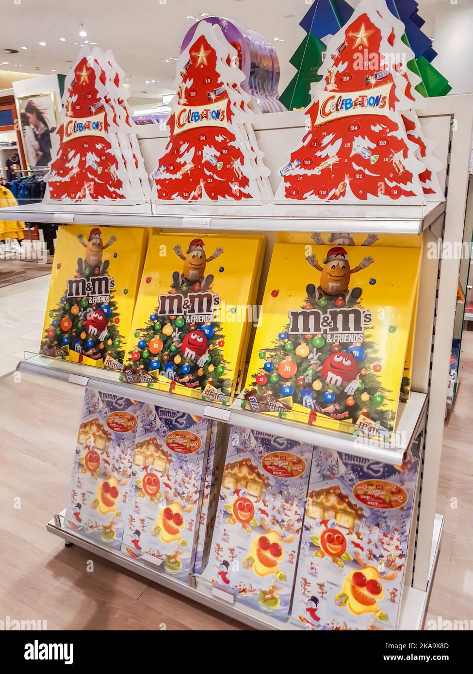 Berlin, Germany, October 2019: a Variety of advent calendars with chocolates and sweets MM and Celebrations on the shelf in the store. Stock Photo