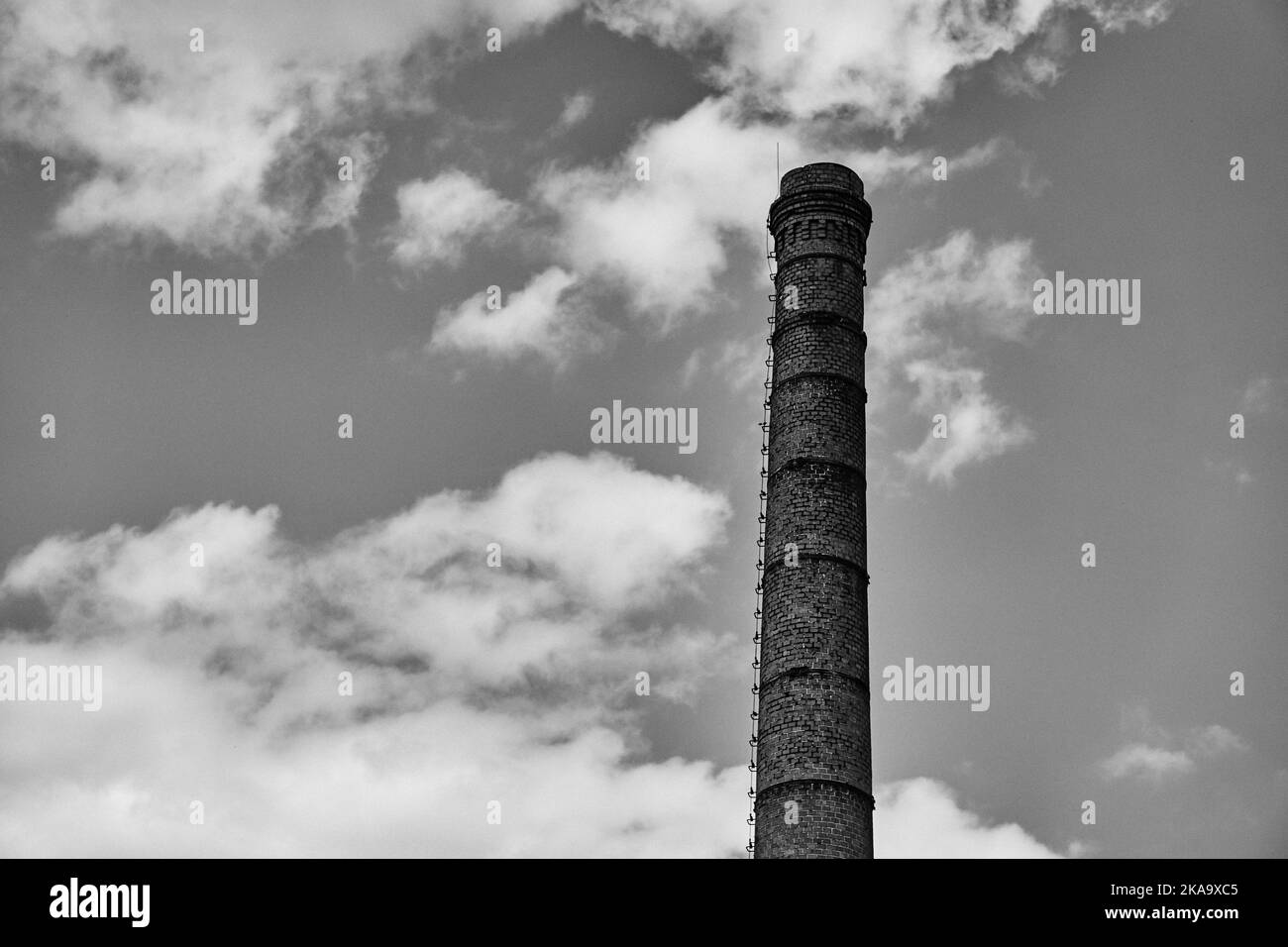 A high chimney made of stone and a sky Stock Photo
