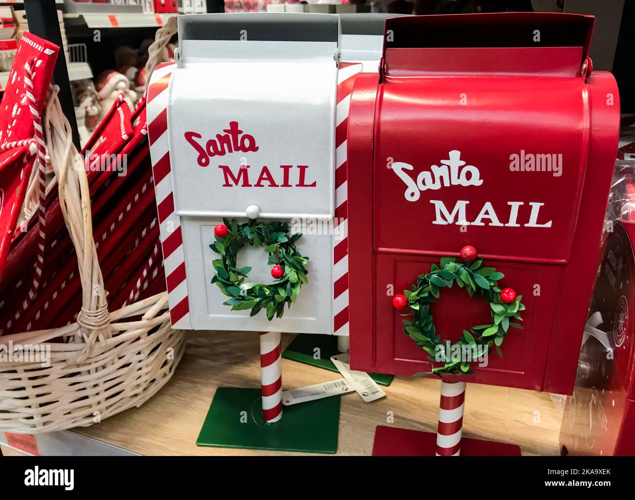 Santa Mail. Red and white mailboxes with green wreaths for letters to Santa Claus. Christmas decorations. Stock Photo