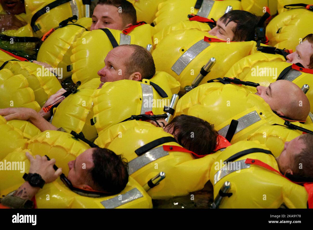 Bremerhaven, Germany. 18th Oct, 2022. Soldiers from the 12th Combat Aviation Brigade prepare to swim towards a life raft as part of dunker training (helicopter over-water survival training) from October 18-19, Bremerhaven, Germany. The training was conducted at the RelyOn Nutec training center and is designed to teach anyone traveling on or over water, how to react before, during, and after a helicopter becomes submerged in water. 12CAB is a team of disciplined warfighting professionals trusted to execute precision aviation operations. Ensuring Soldiers successfully complete dunker trainin Stock Photo