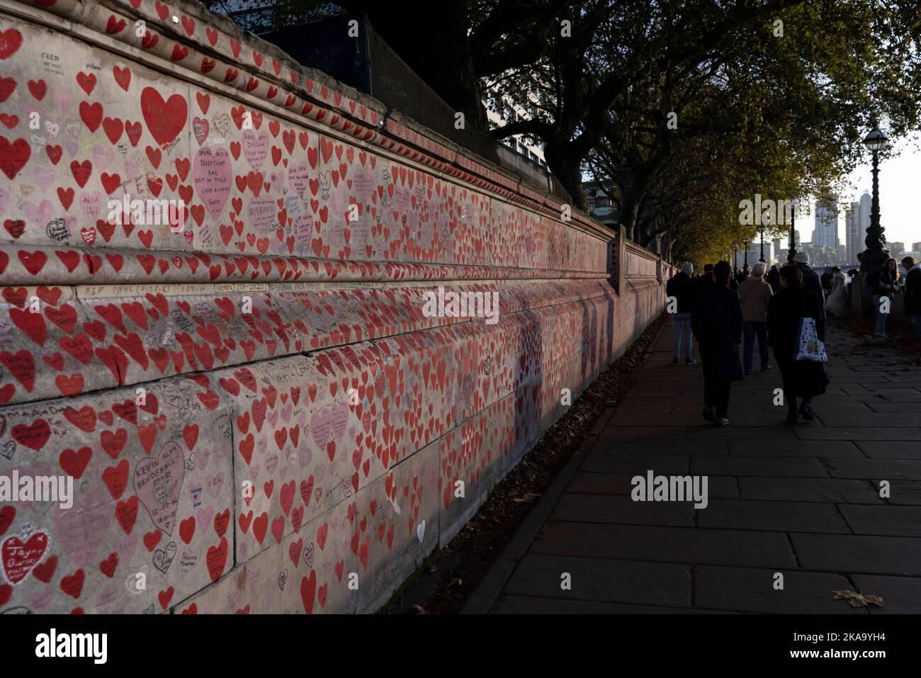 The National Covid Memorial Wall at dusk, kilometre-long wall on the Southbank, decorated with love hearts, names, dates, and messages, London, UK Stock Photo