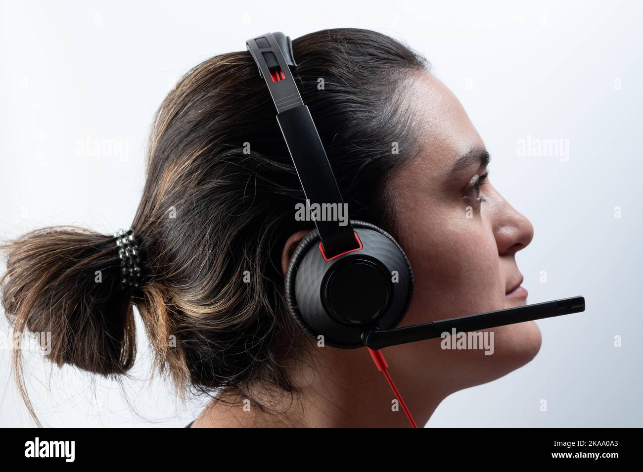 Online support woman operator side view isolated on studio background Stock Photo