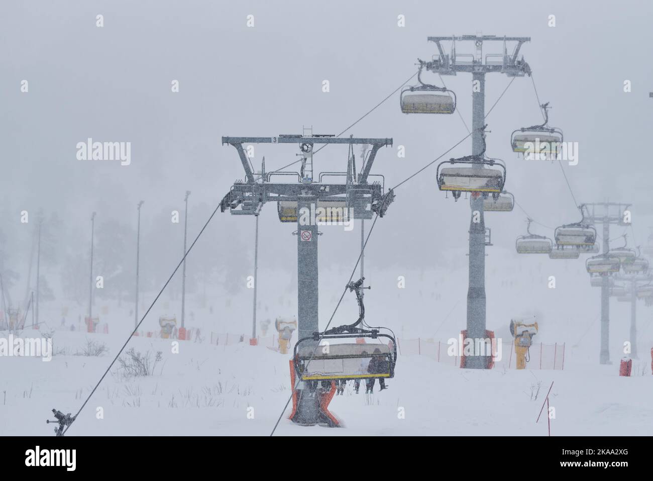 Ski lift in the ski resort in the snowfall. Stock Photo