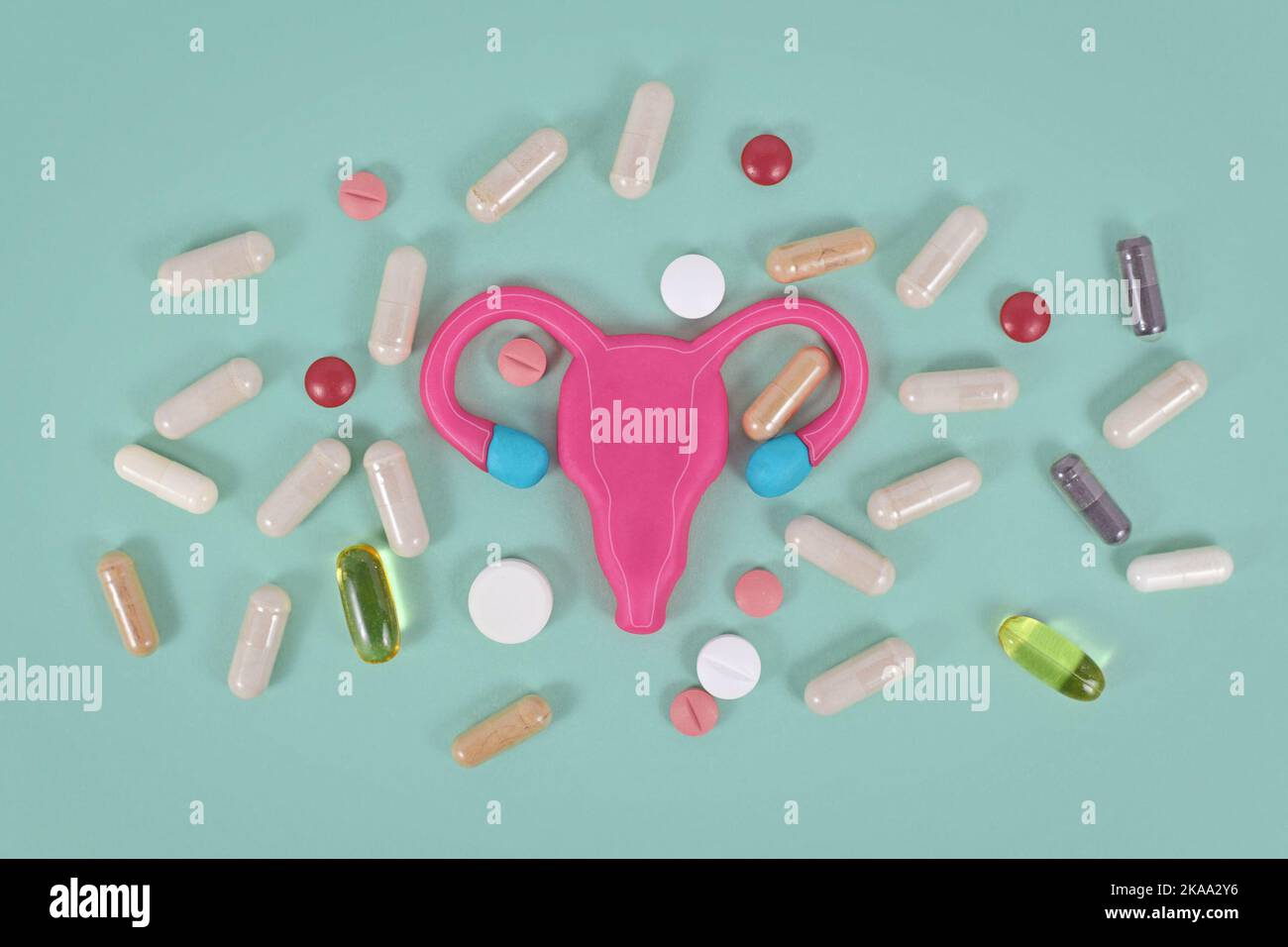 Concept for using medicine to boost female fertility showing stylized uterus and pills Stock Photo