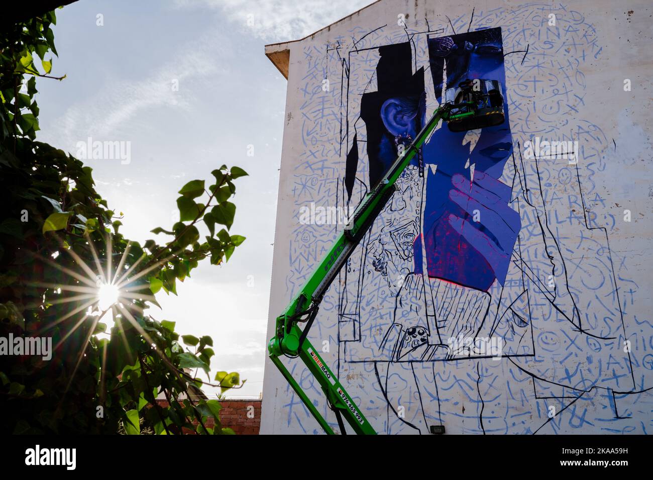 Artist Murfin paints a mural during Asalto International Urban Art Festival in Barrio Isabel of Zaragoza, Spain Stock Photo