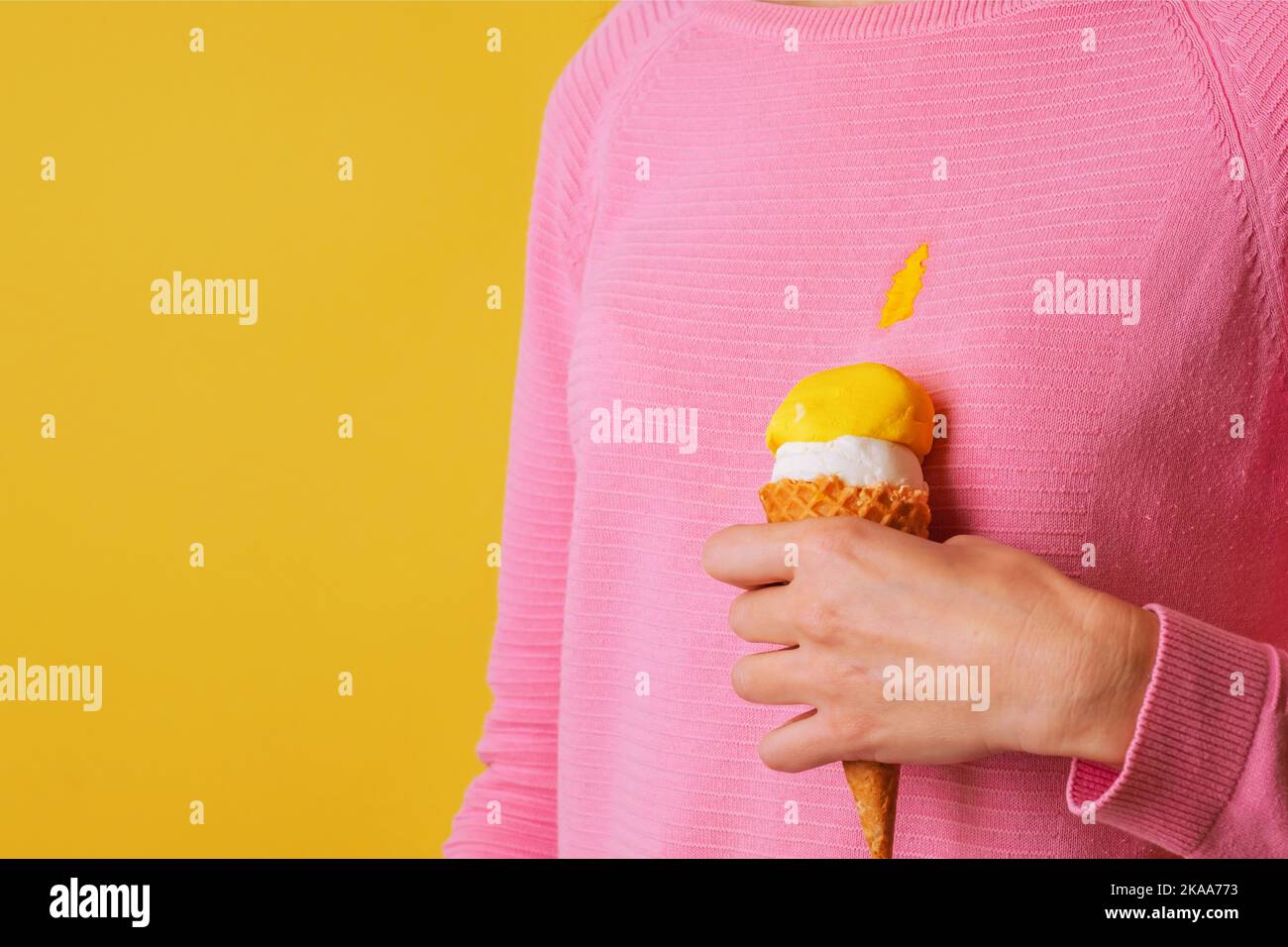 The girl wearing stained blouse holding ice cream. Spilling ice cream on clothes Stock Photo Alamy