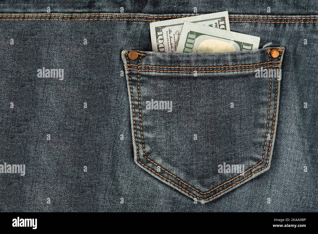 Stack of 100 dollar bills in jeans pocket. Money in the back pocket of my jeans. The concept of investment, cash, wealth and profit Stock Photo