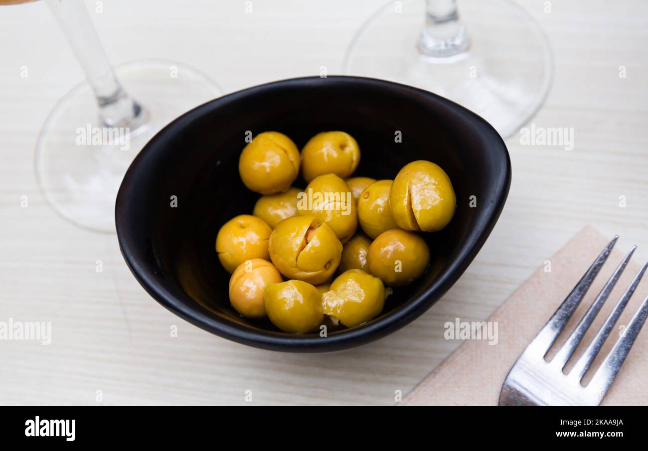 Pickled olives with a stone a typical Spanish tapas Stock Photo Alamy