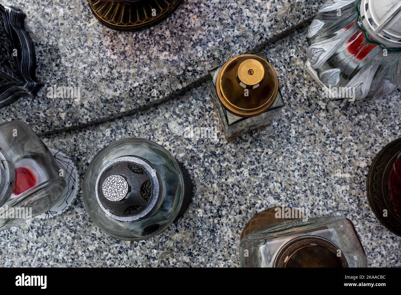 Candles and flowers on graves in the cemetery during the All Saint’s