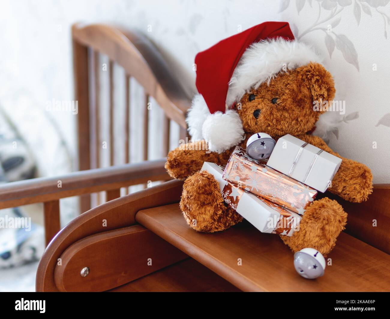 Teddy bear in Santa Claus hat. Plush toy with Christmas presents