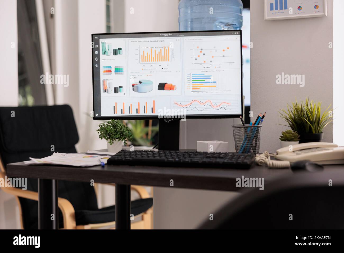 Desktop computer running financial management software on office desk