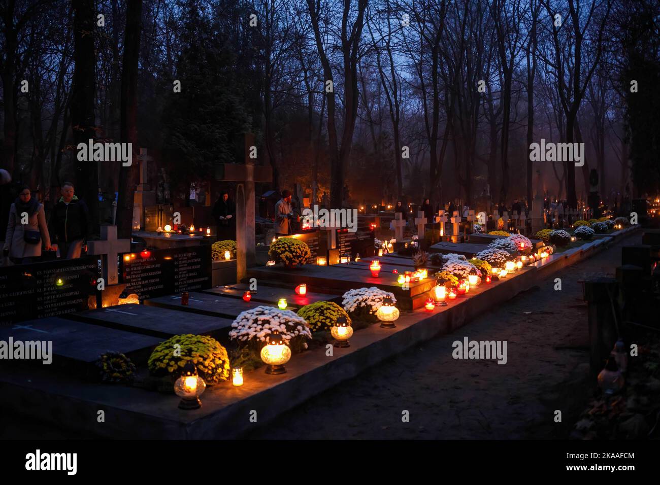 warsaw-poland-01st-nov-2022-a-line-of-tombs-covered-with-lit