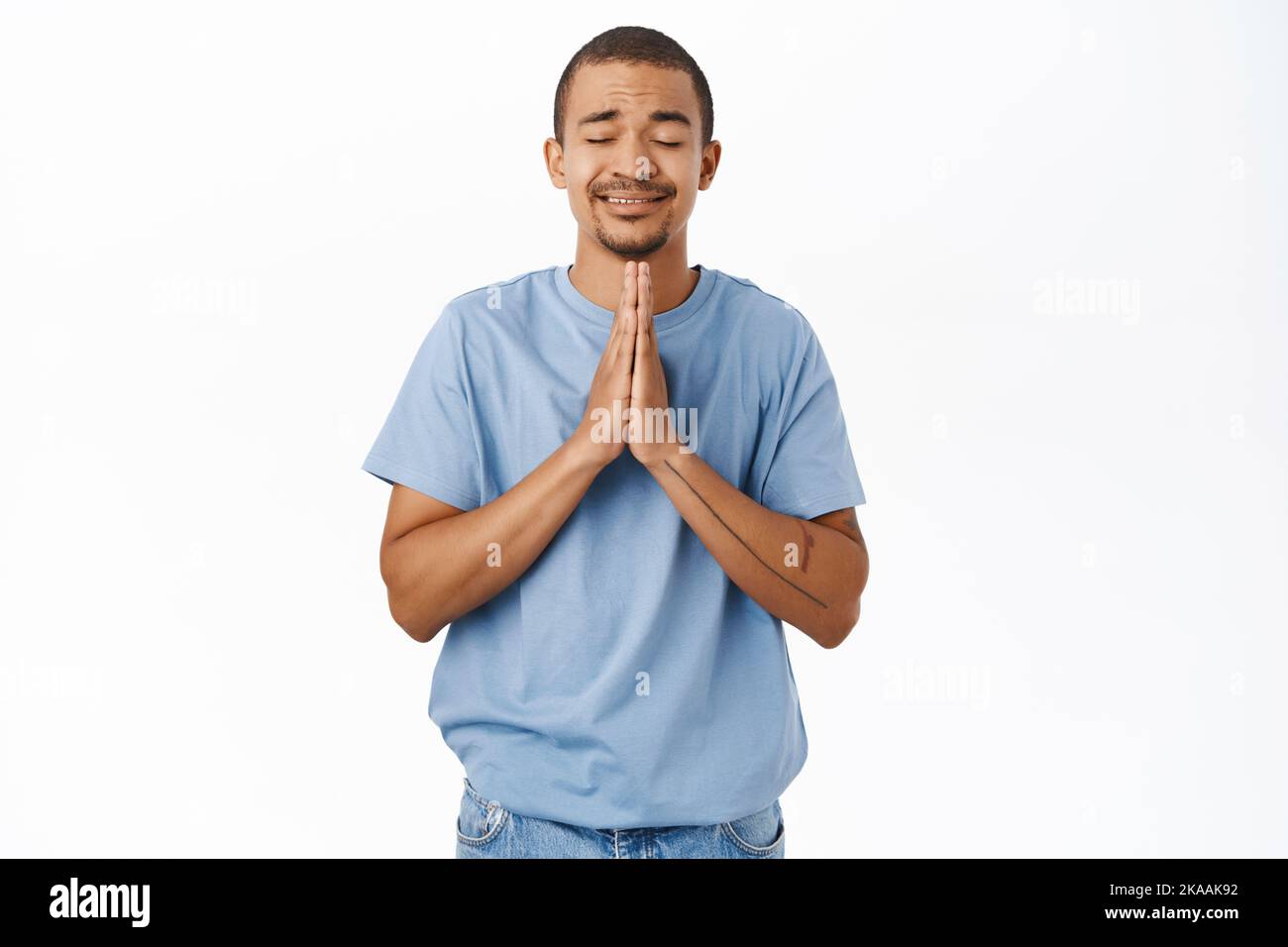 Image of hopeful man praying, begging please, standing over white ...