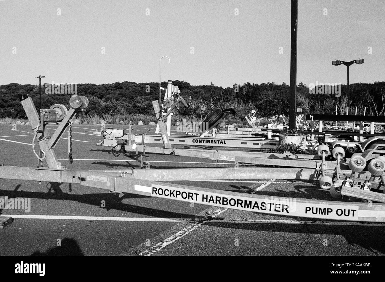A row of boat trailers in a parkinglot with the first labeled Rockport