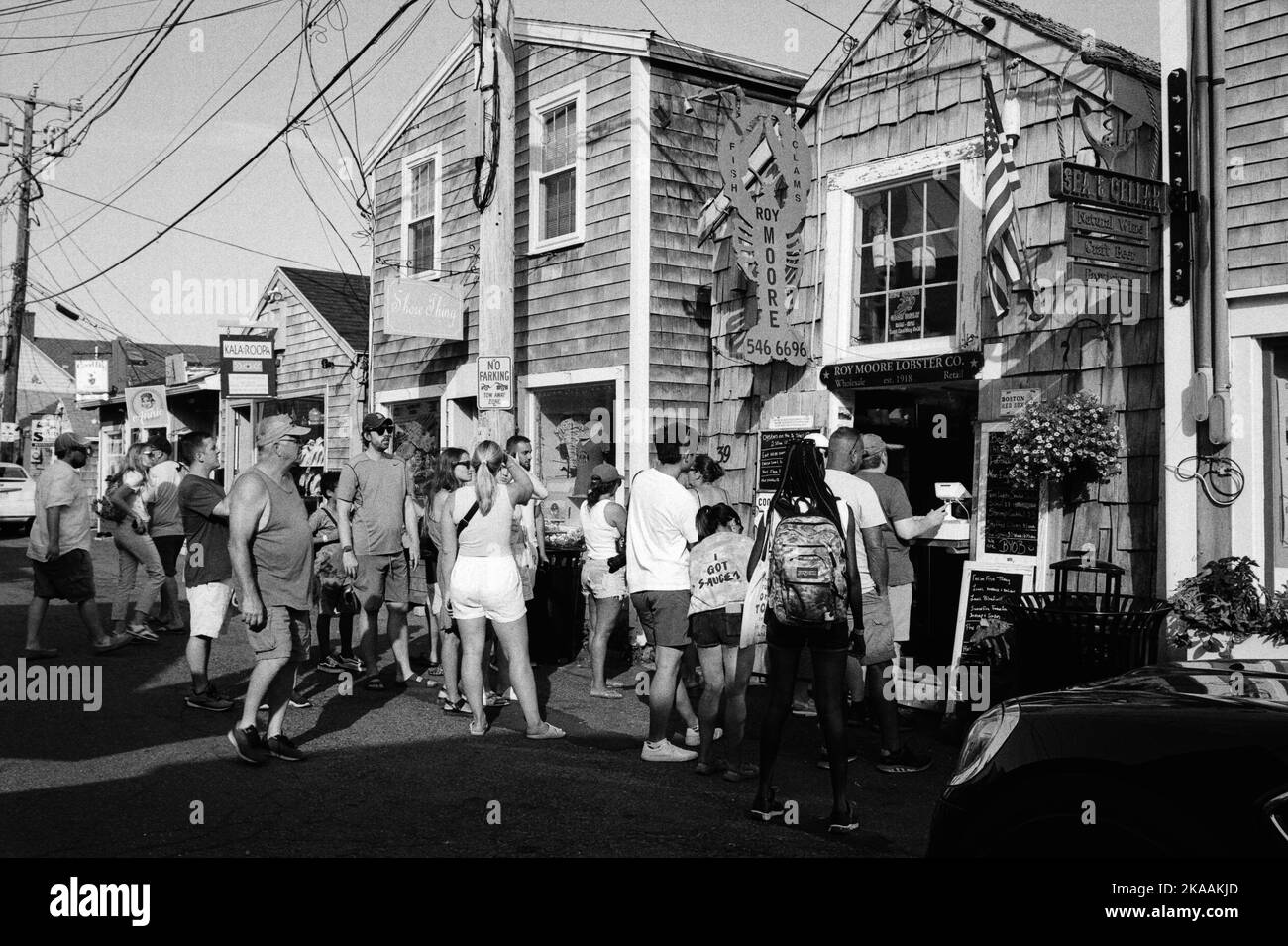 The landmark Roy Moore Lobster Company with a line across the street for lunch in Rockport, Massachusetts. The image was captured on analog black-and-wh Stock Photo