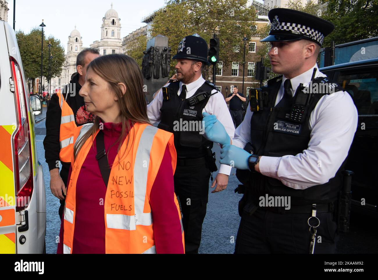 London, UK. 1st November, 2022. Just Stop Oil protesters tried to scale the gates at 10 Downing Street today, whilst others sat on the road at Whitehall blocking traffic and glued their hands to the road. They were moved and searched by the Met Police. JSO are demanding that the UK Government agrees to end all new oil and gas. From today JSO are to pause their campaign of civil resistance. They said 'we are giving time to those in Government who are in touch with reality to consider their responsibilities to this country at this time'. They say that if they do not receive a response from Minis Stock Photo