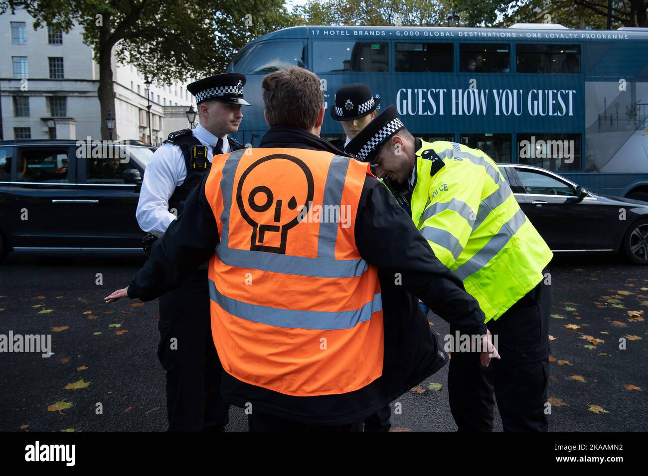 London, UK. 1st November, 2022. Just Stop Oil protesters tried to scale the gates at 10 Downing Street today, whilst others sat on the road at Whitehall blocking traffic and glued their hands to the road. They were moved and searched by the Met Police. JSO are demanding that the UK Government agrees to end all new oil and gas. From today JSO are to pause their campaign of civil resistance. They said 'we are giving time to those in Government who are in touch with reality to consider their responsibilities to this country at this time'. They say that if they do not receive a response from Minis Stock Photo