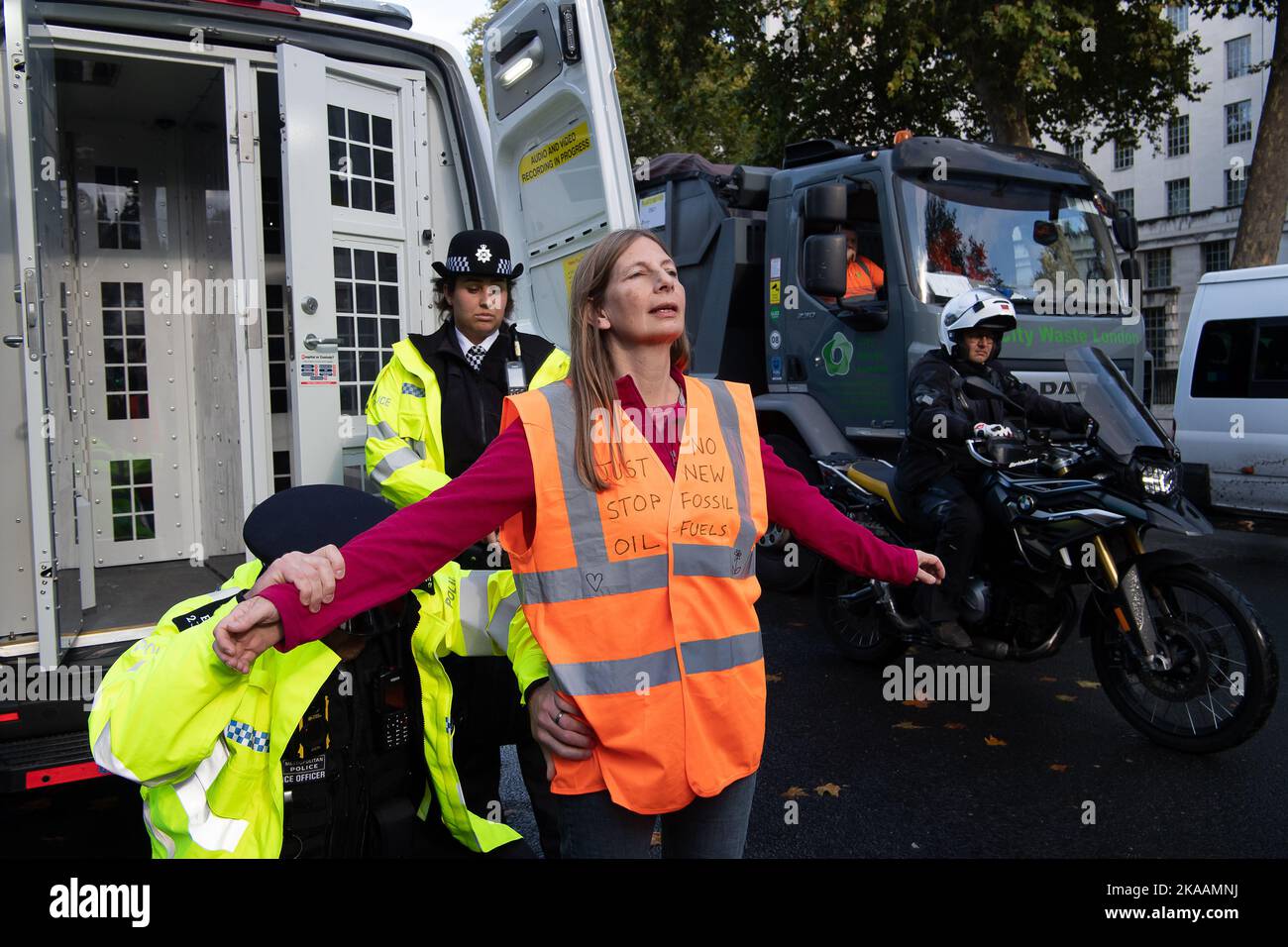 London, UK. 1st November, 2022. Just Stop Oil protesters tried to scale the gates at 10 Downing Street today, whilst others sat on the road at Whitehall blocking traffic and glued their hands to the road. They were moved and searched by the Met Police. JSO are demanding that the UK Government agrees to end all new oil and gas. From today JSO are to pause their campaign of civil resistance. They said 'we are giving time to those in Government who are in touch with reality to consider their responsibilities to this country at this time'. They say that if they do not receive a response from Minis Stock Photo