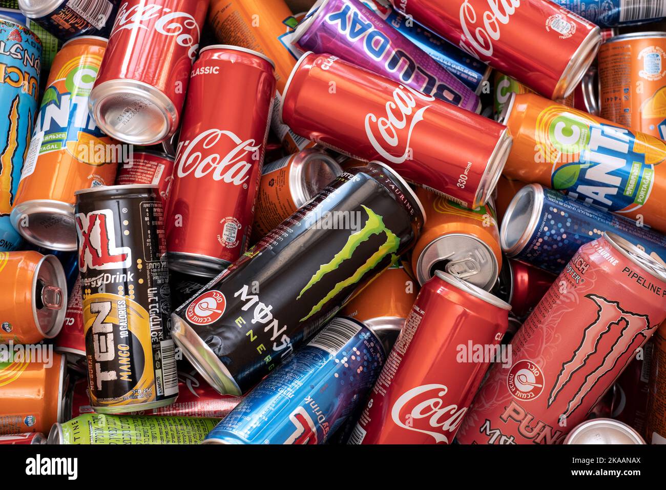 Israel - 31 may 2022: Heap of aluminum cans in trash for recycling waste. Fanta, Coca-Cola, and energetic drinks. Sugar in drink. Editorial Stock Photo