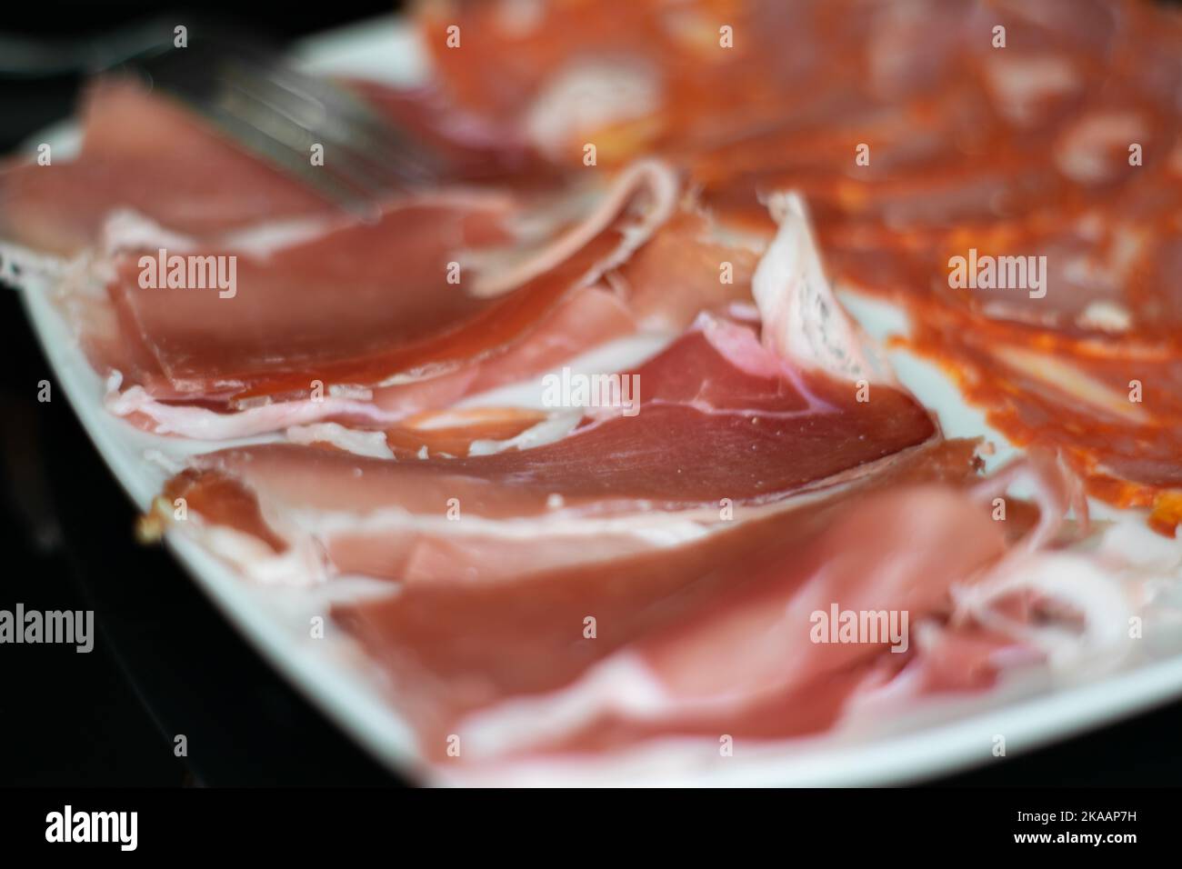 Tapas food, raclette and smoked ham and chorizo. Portuguese food and flavors. Stock Photo