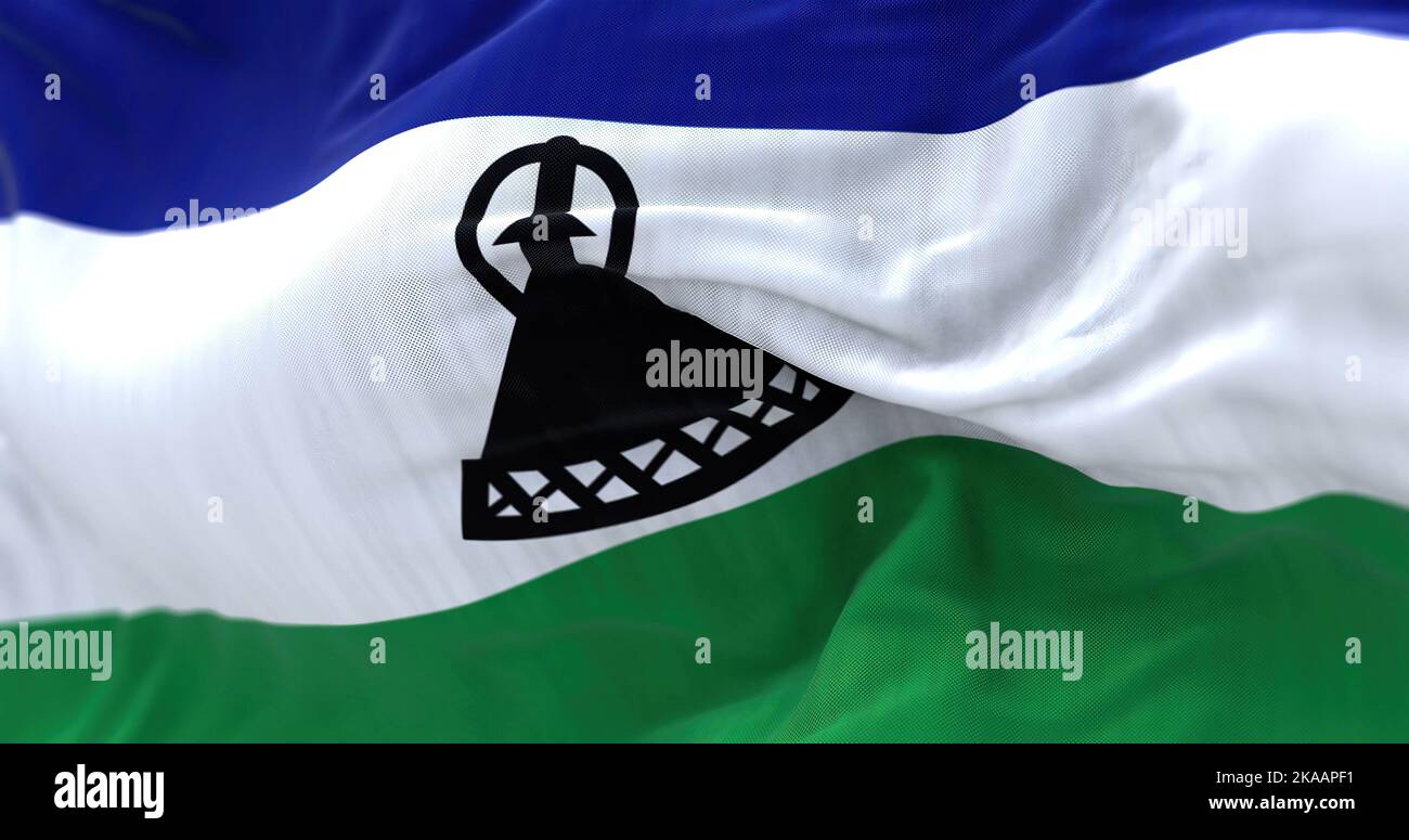 Close-up view of the Lesotho national flag waving. The Kingdom of Lesotho is a state in southern Africa, one of the three kingdoms of Africa. Fabric t Stock Photo