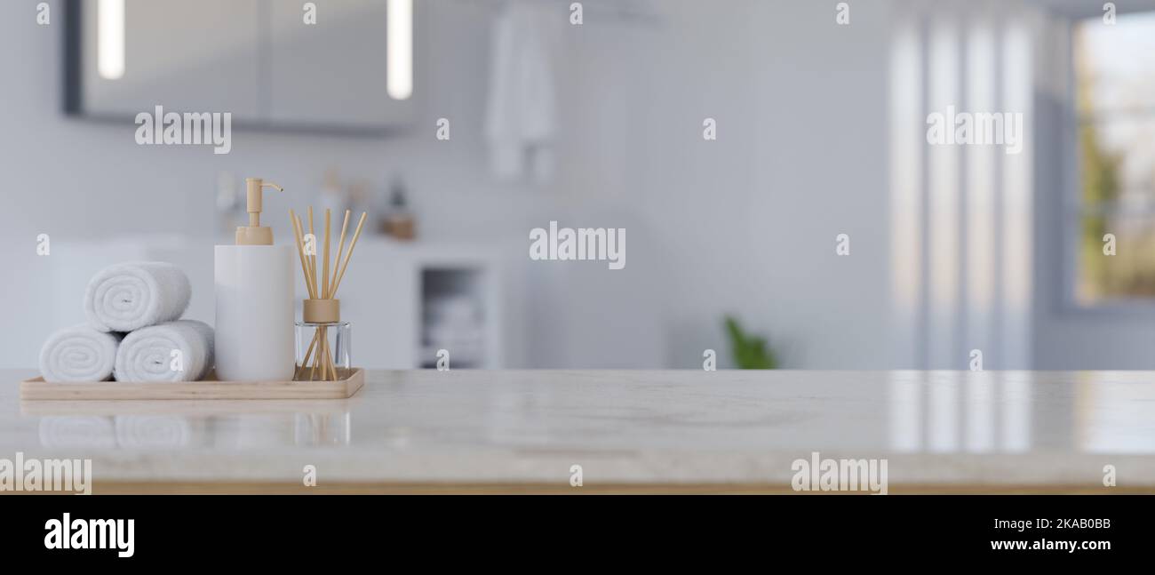 Copy space for product display, hand towels, shampoo bottle and aroma diffuser on white marble bathroom tabletop over blurred background of modern whi Stock Photo