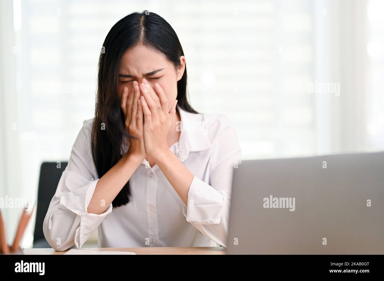 Stressed and sad young Asian businesswoman or female college student