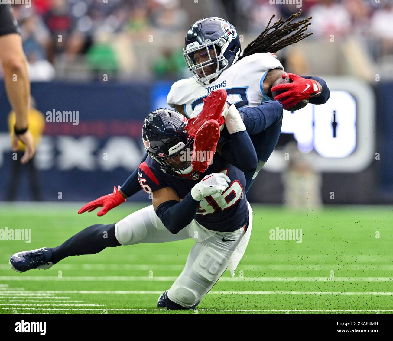 Houston, Texas, USA. 1st Oct, 2017. Tennessee Titans running back Derrick  Henry (22) looks to elude Houston Texans defensive end Jadeveon Clowney  (90) on a running play during the third quarter of