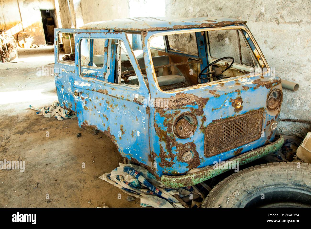 old  rotten car in abandoned factory Stock Photo