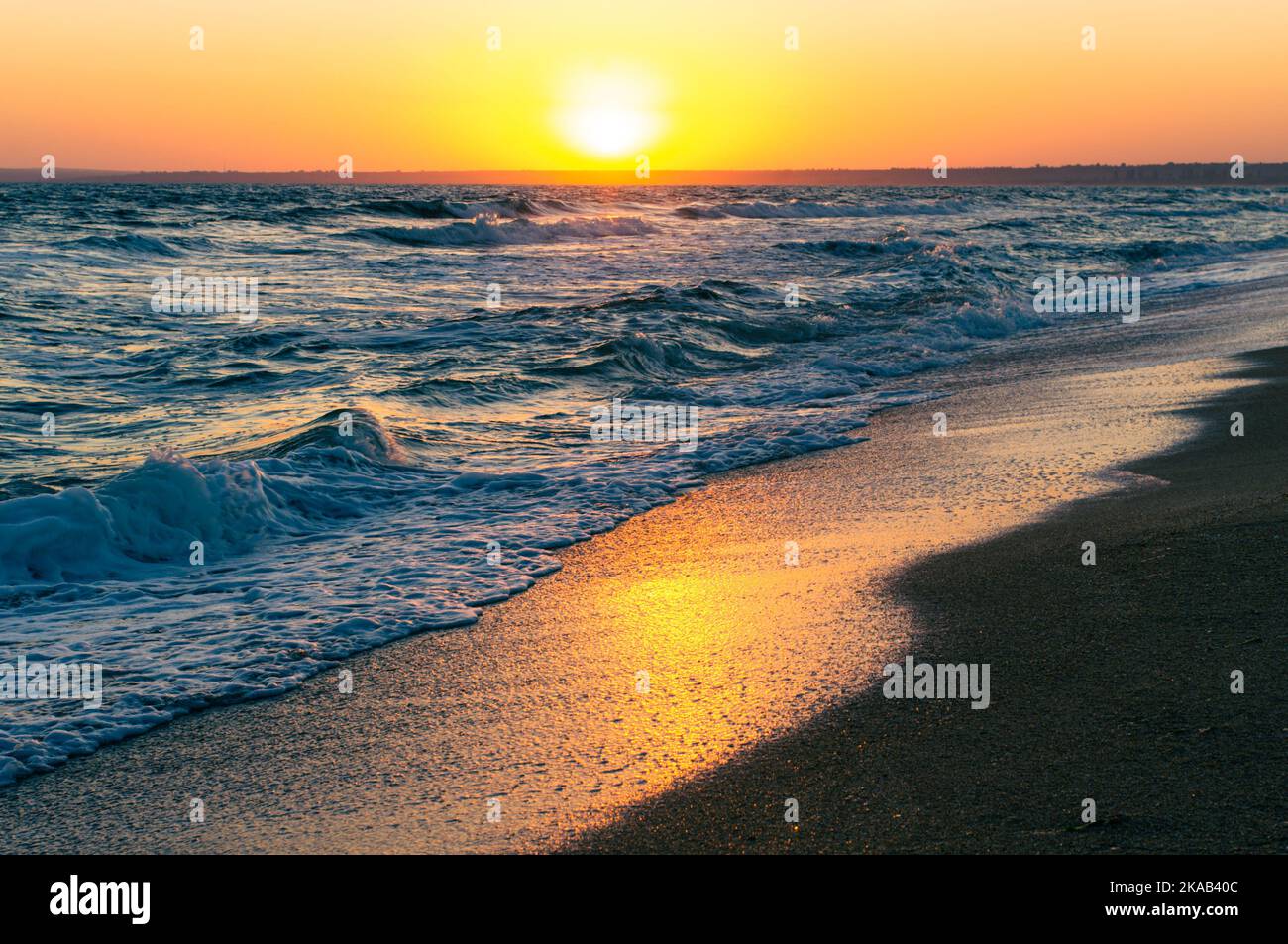 Sunrise on the Sea of Azov, sun and waves in the morning. Front view. Stock Photo