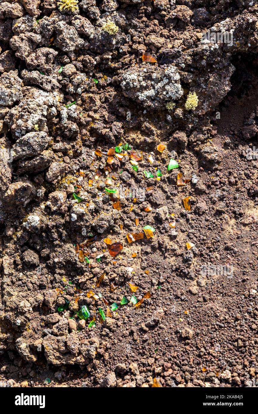 detail of volcanic area in Lanzarote,poluted by broken glass of a bottle Stock Photo