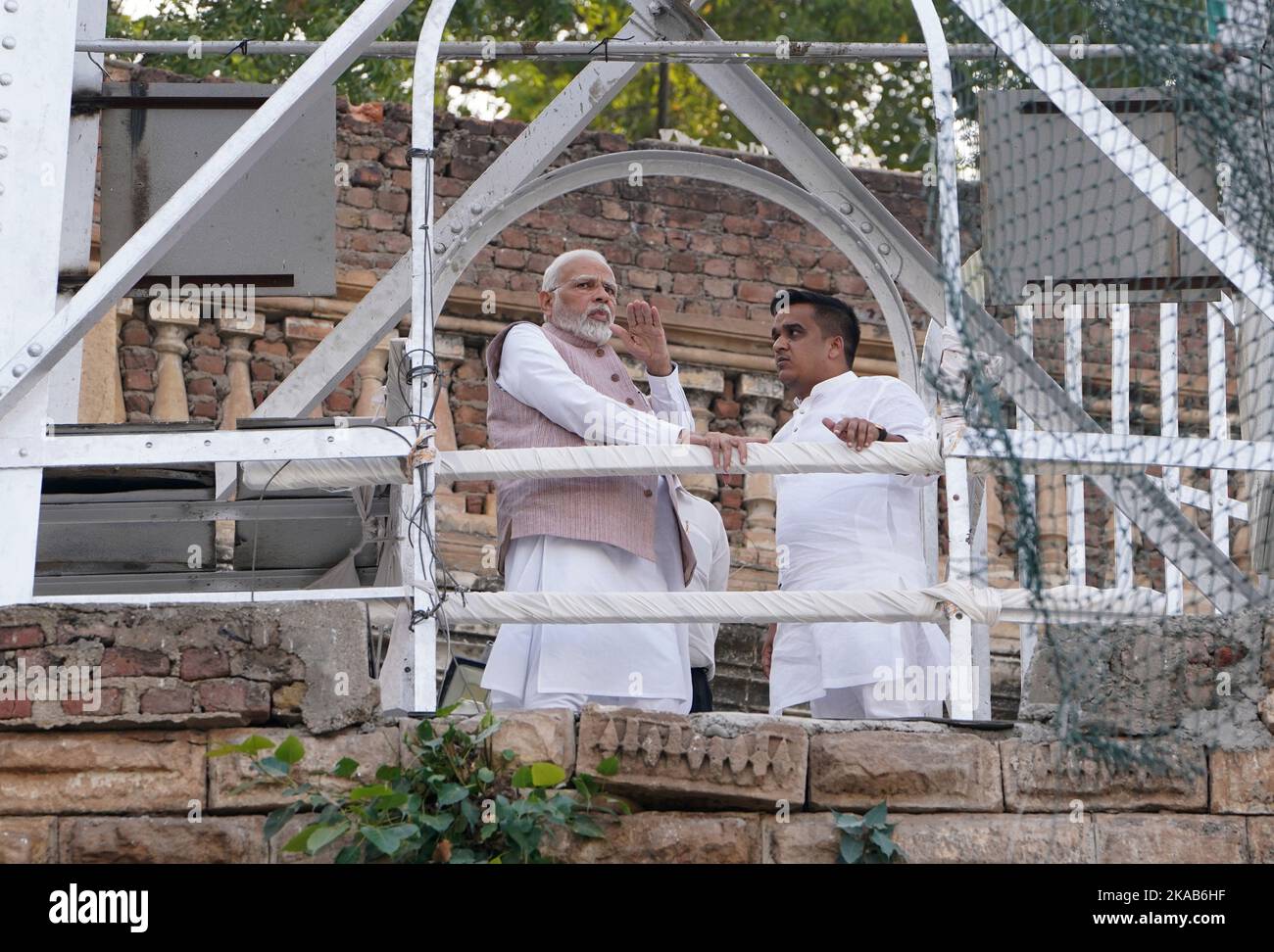 Gujarat. 1st Nov, 2022. Indian Prime Minister Narendra Modi (L) looks at a collapsed bridge in Morbi district of India's western state of Gujarat, Nov. 1, 2022. Modi Tuesday inspected the bridge collapse site in the western state of Gujarat where more than 100 people were killed, officials said. Credit: Str/Xinhua/Alamy Live News Stock Photo