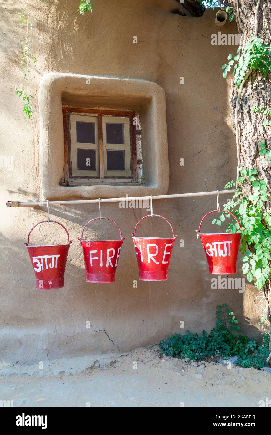 red fire buckets filled with sand to protect in case of fire Stock