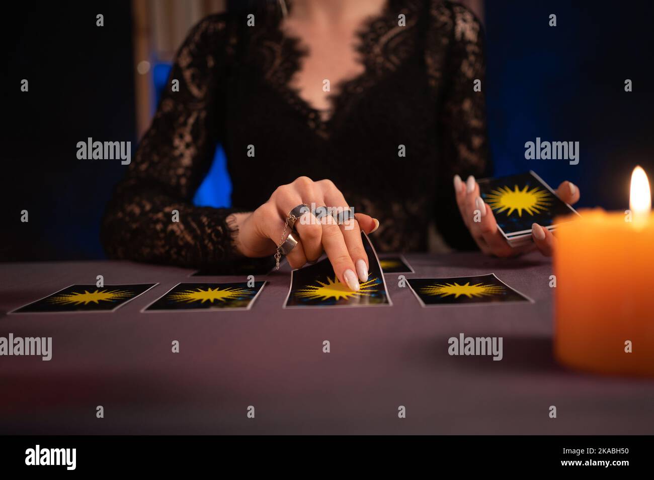 A fortune teller reading Tarot cards. Hands close up. divination