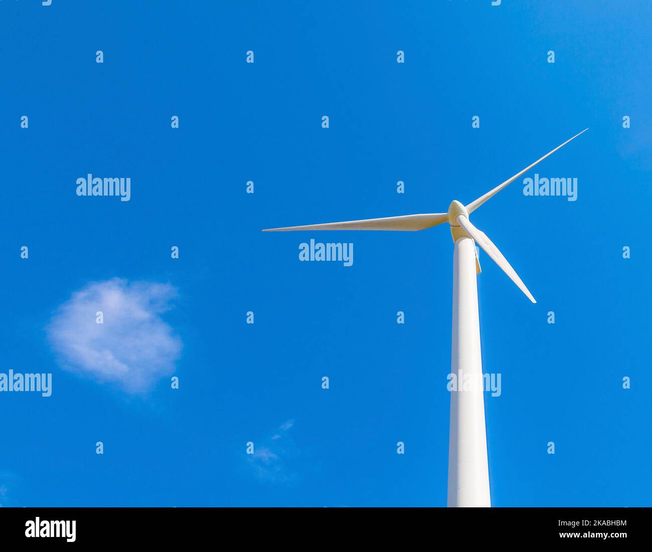 wind turbine generating electricity on blue sky Stock Photo - Alamy