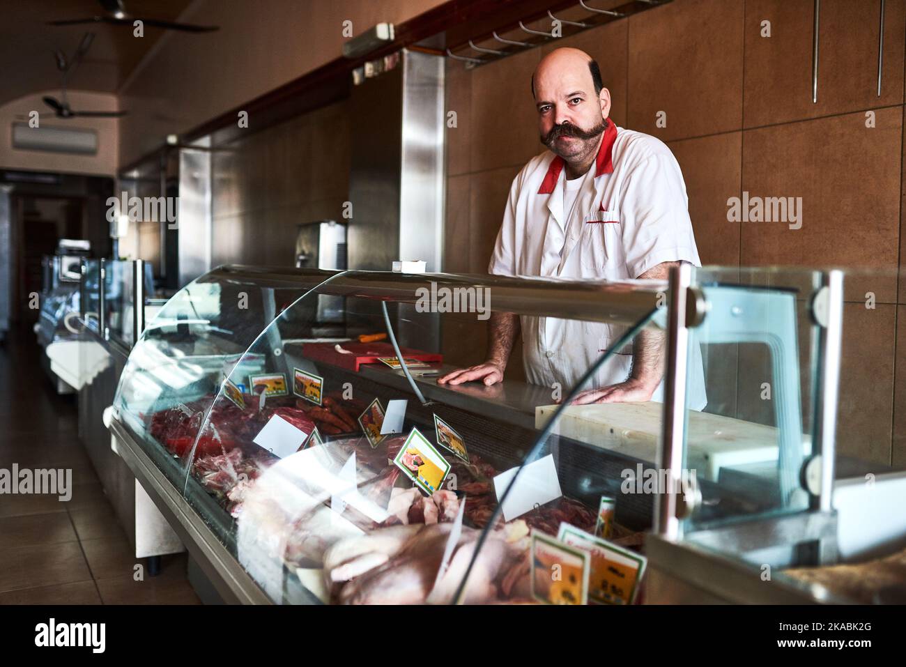 I have my best cuts out on display. a butcher at his store. Stock Photo