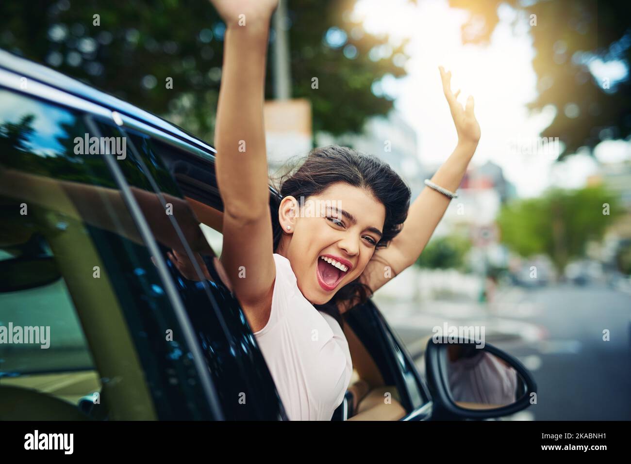 Having your own car is the ultimate freedom. an attractive young woman