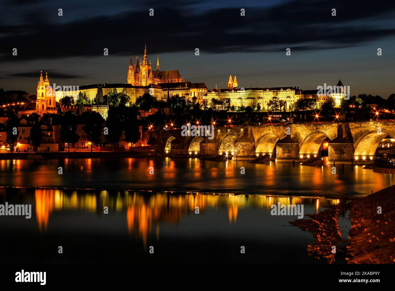 Evening view of illuminated Prazsky Hrad, Charles bridge and Vltava river in Prague, Czech Republic. Stock Photo