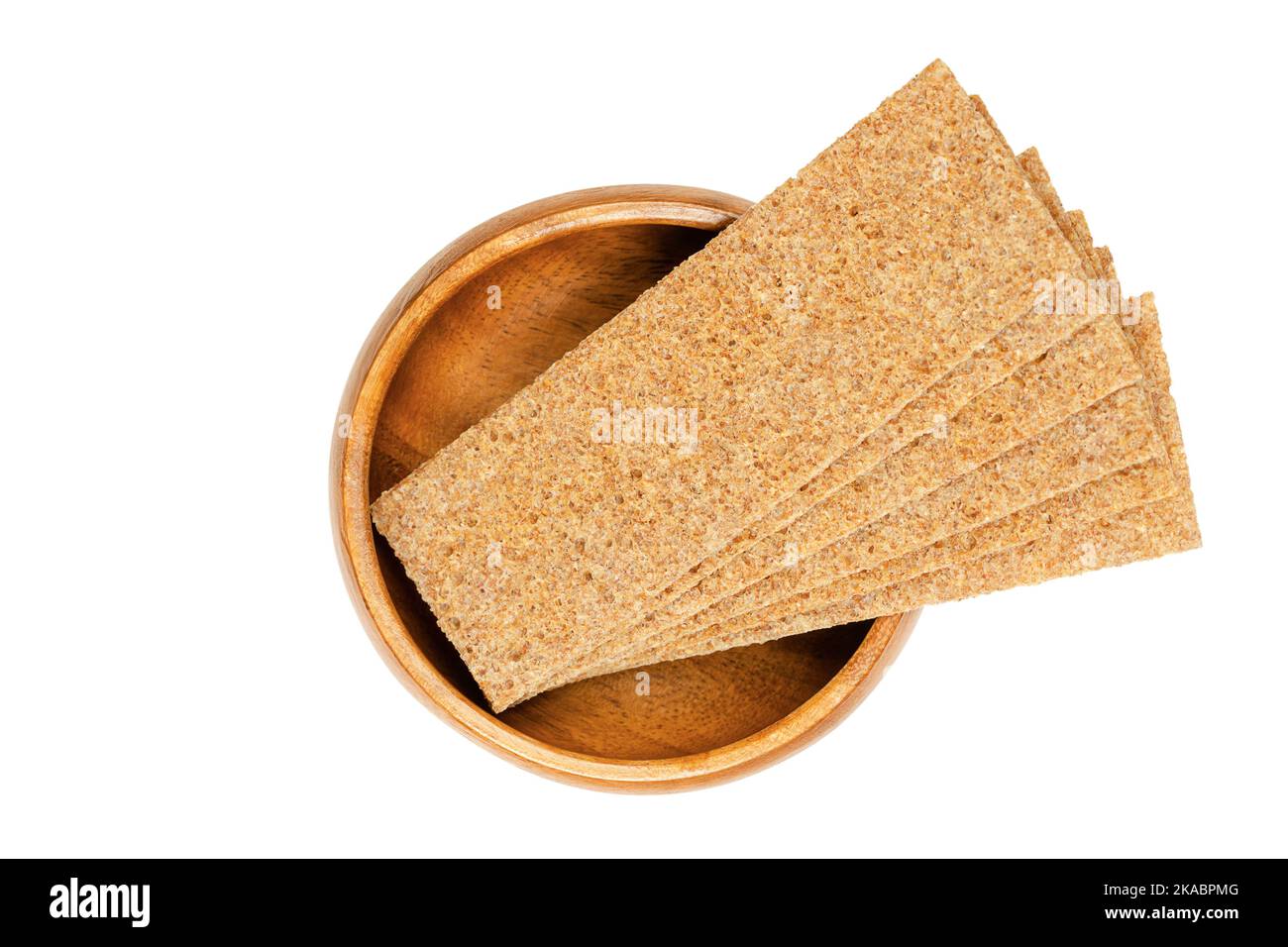 Thin slices of sourdough whole grain rye crispbread, in a wooden bowl. Rectangle shaped, flat and dry, crunchy and crisp cracker and light bread. Stock Photo