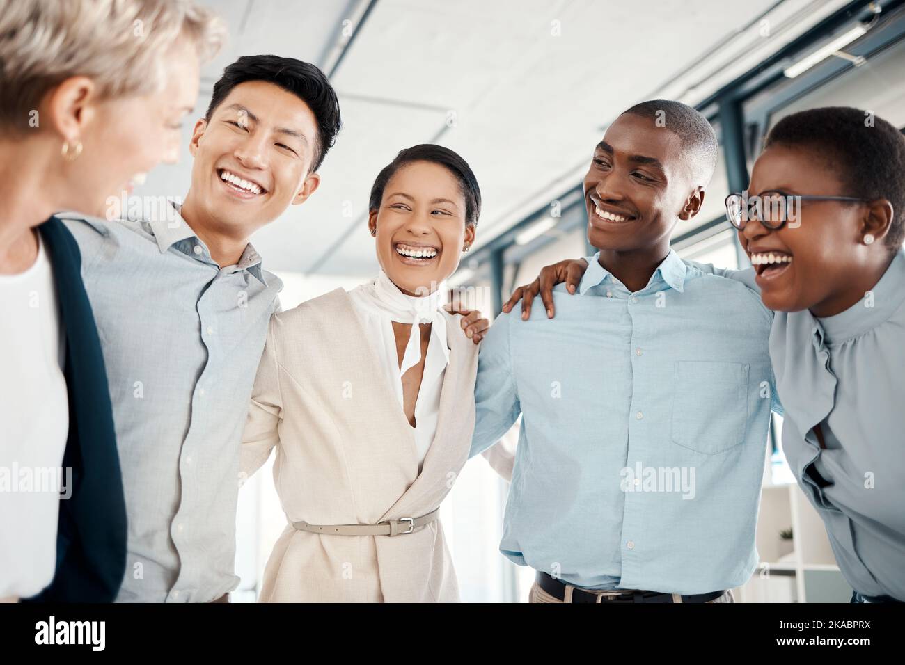 Happy, team building and business people hug in a meeting for successfully coworking in group collaboration. Diversity, teamwork and employees excited Stock Photo