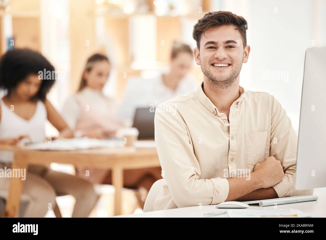 Smile, portrait and businessman working on a computer for marketing, communication and corporate at work. Happy, startup and young worker in Stock Photo