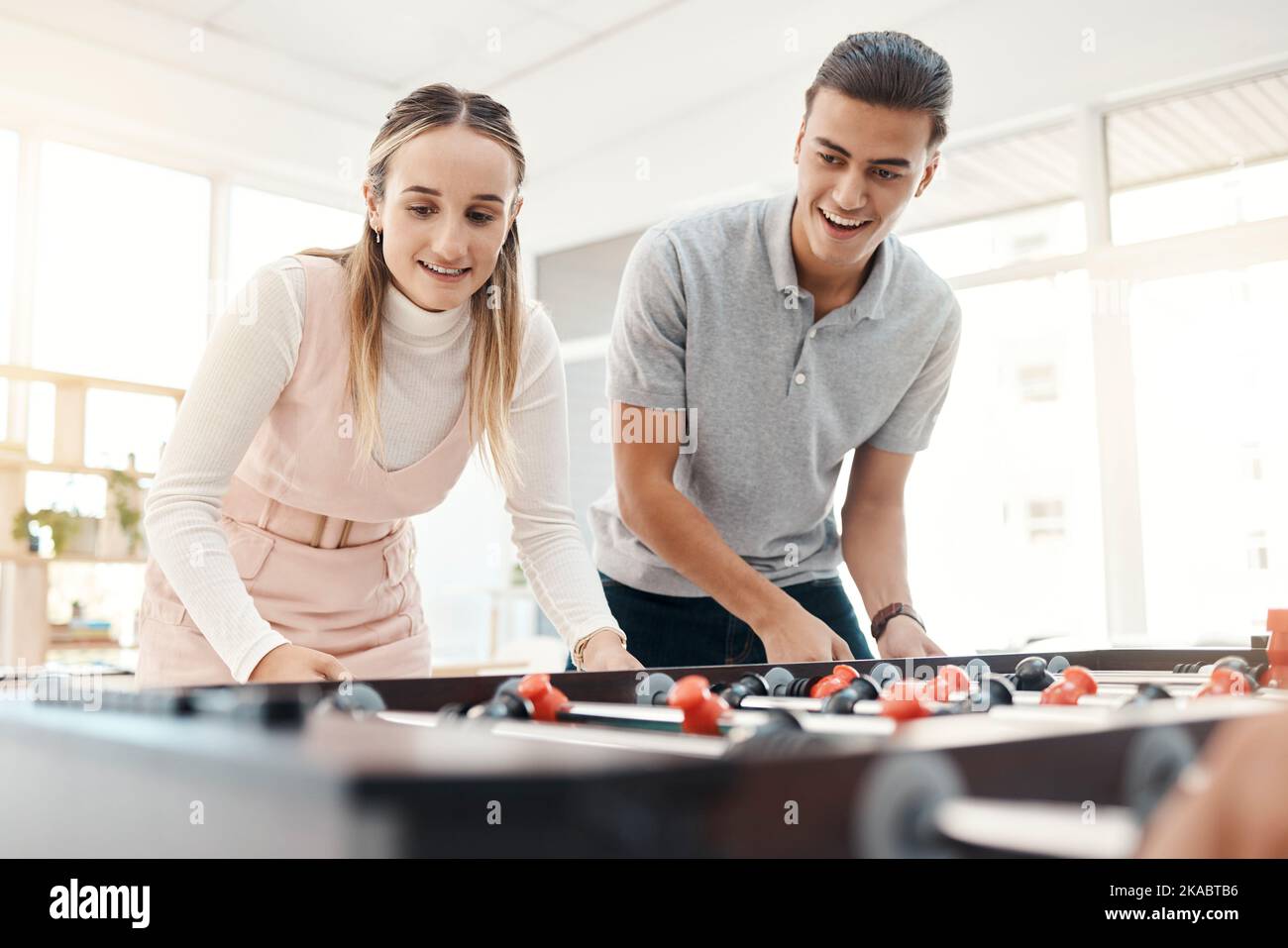 Office team, table soccer and team building while playing foosball game