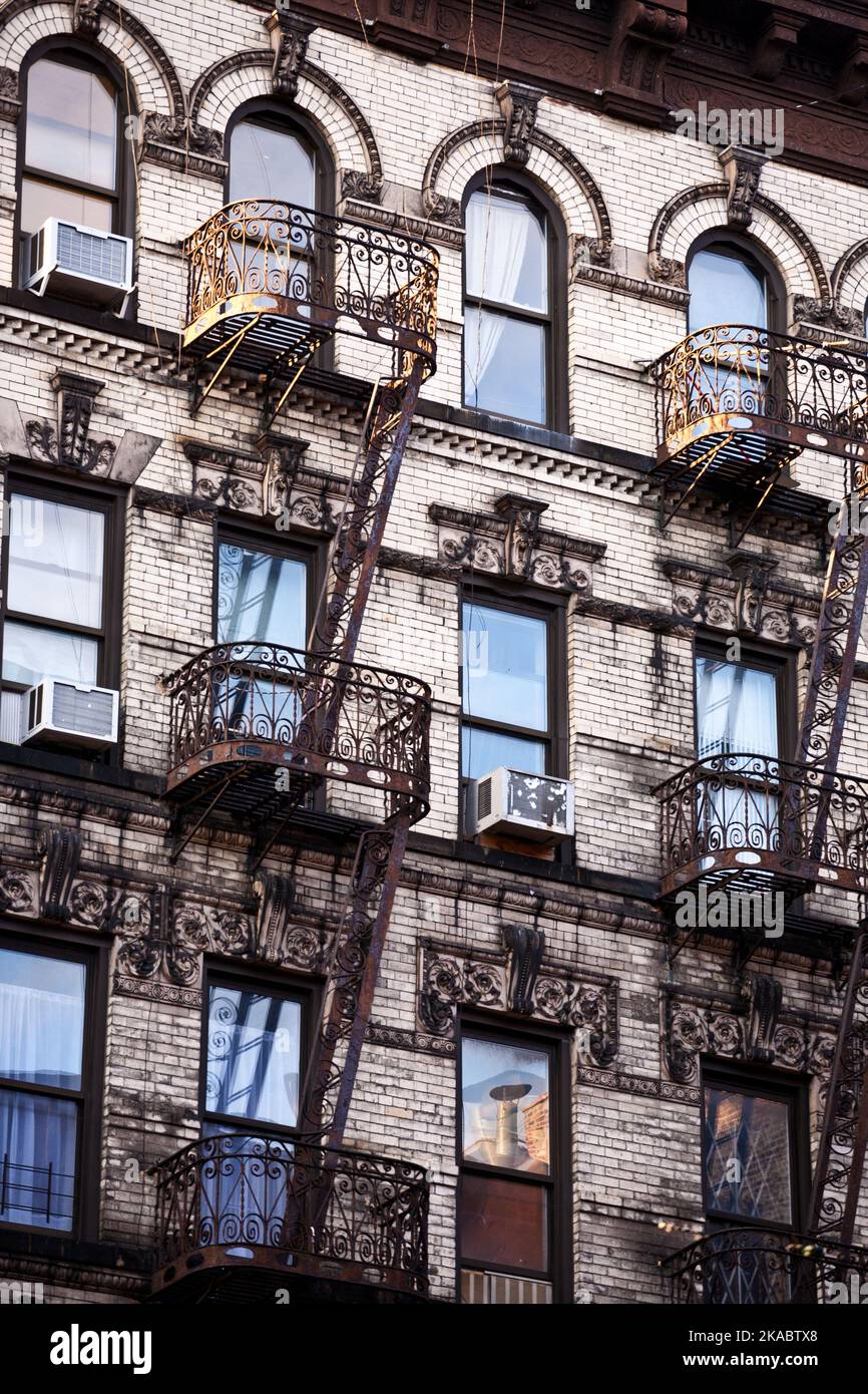 old iron fire escape rescue ladders at old houses in beautiful light