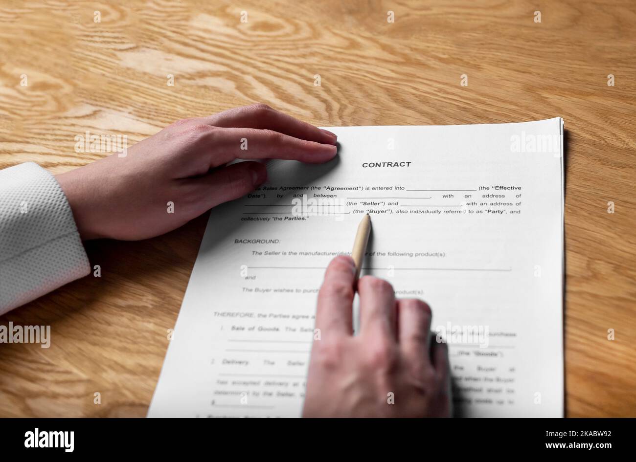 Paper sales contract on office desk in hands with pen, pov. Stock Photo